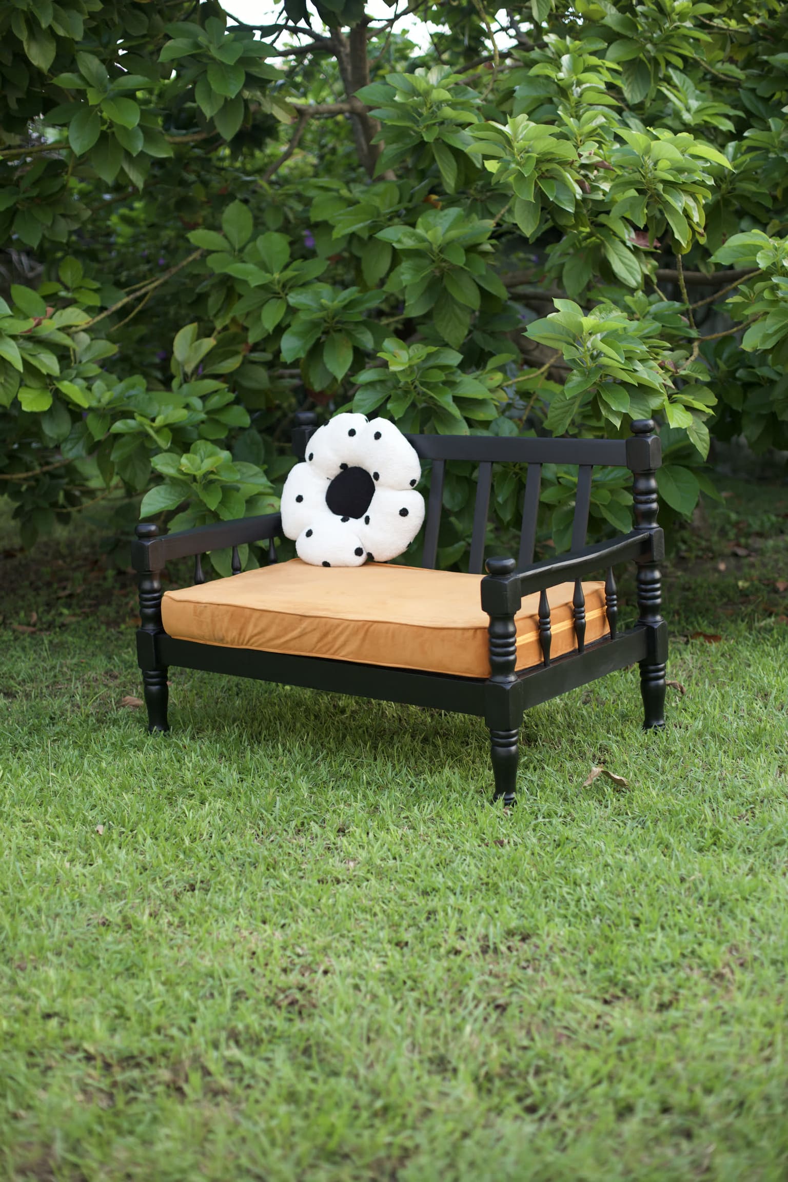 Restore — a reclaimed bench stripped and relacquered in black with an ochre cushion