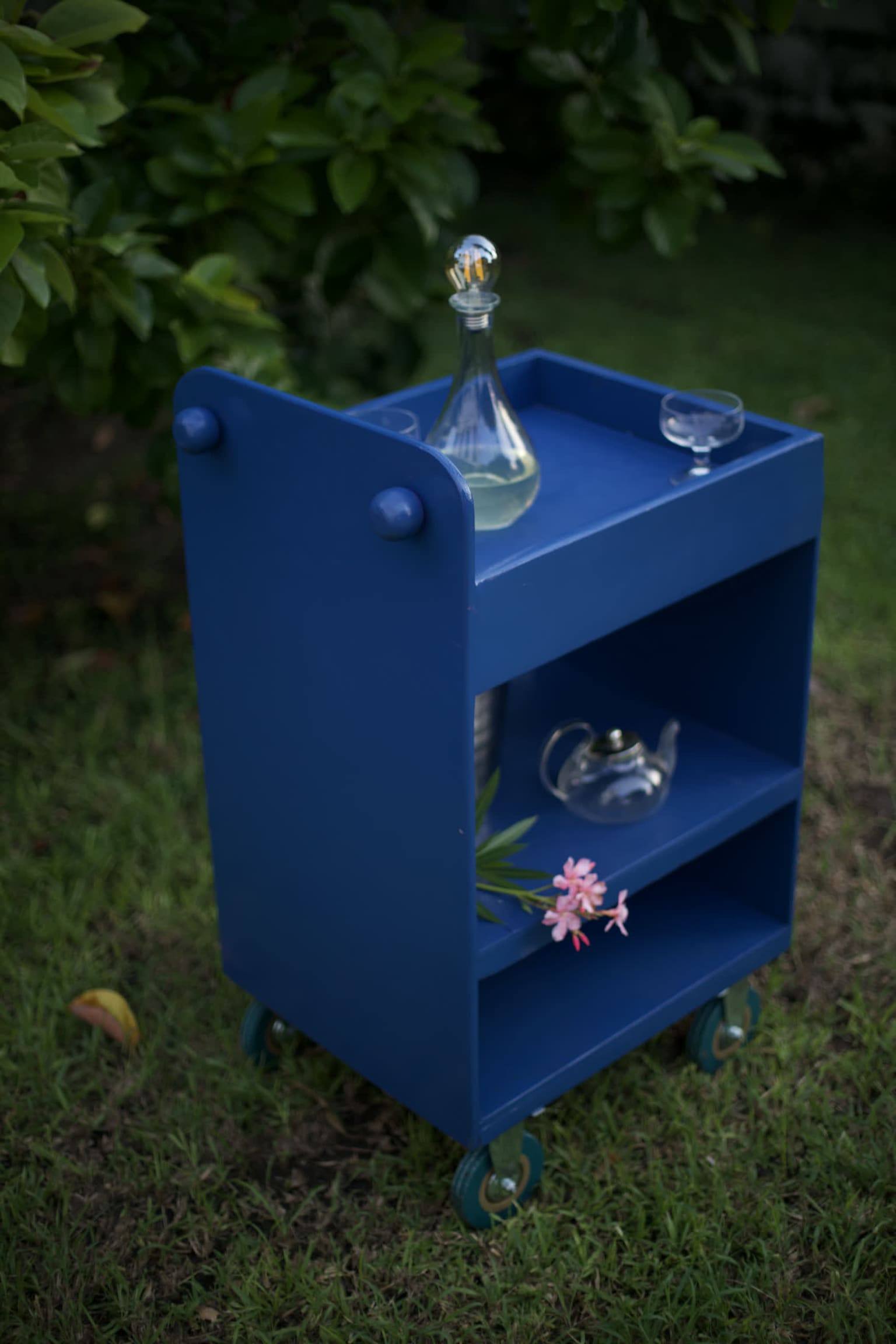 Reimagine — a rebuilt serving cart in deep blue, staged with glassware